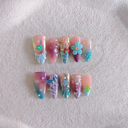 Handmade nail art sculpture set with embossed flower and butterfly designs in four sizes for almond-shaped nails