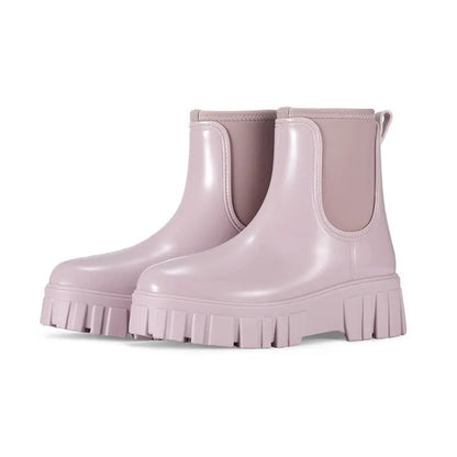 Women's creamy-white low tube PVC rain boots with a flat heel and thickening sole, shown from the side.
