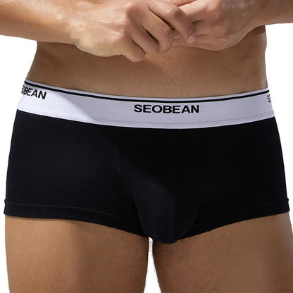 Men's solid colour cotton low waist boxers in sizes M to XXL.