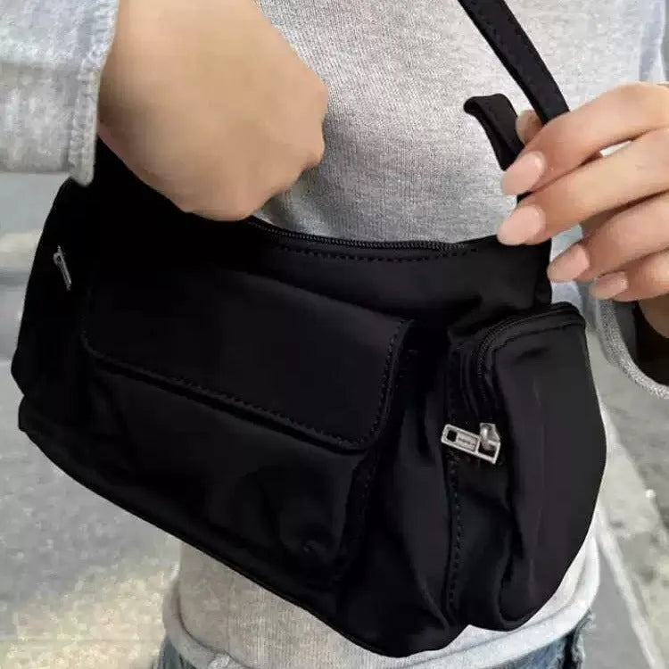 Black lightweight nylon shoulder bag with two pockets and side stitch detailing, dimensions 24cm x 9cm x 14cm.