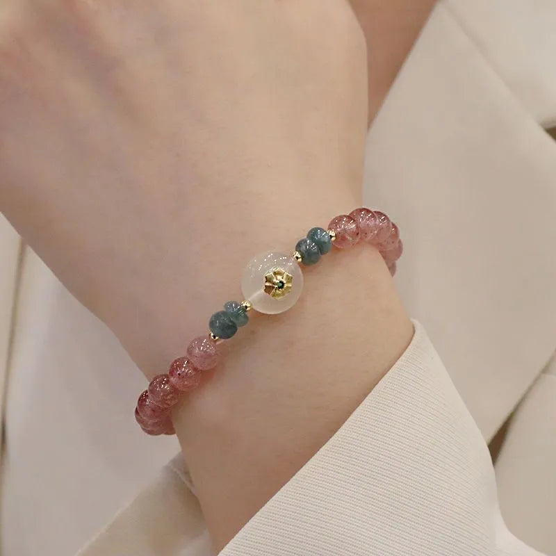 Women's bracelet with strawberry quartz stones and blue water emerald round jade pendant featuring peace buckle closure