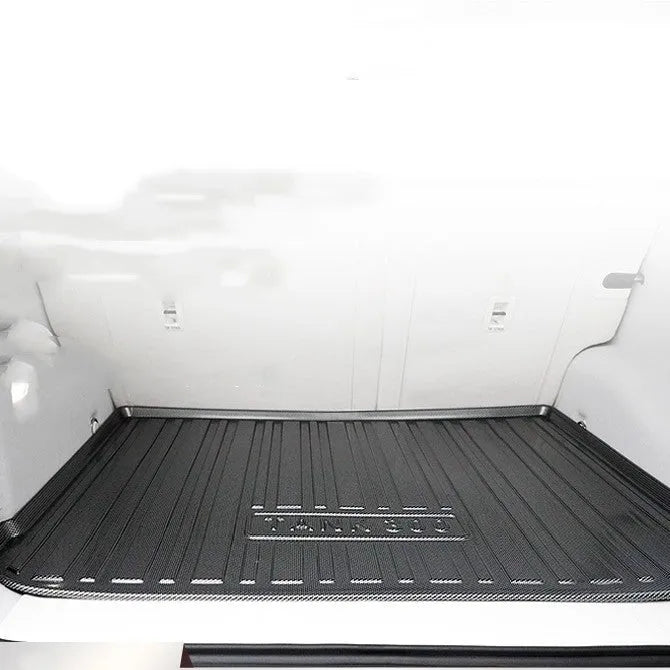 Black carbon fibre pattern tailored car boot liner mat fitted in an estate vehicle
