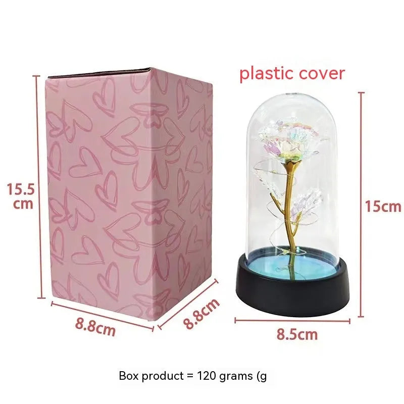 Glass cover small night lamp with plastic flowers, 15cm height, black base, showing colour light options