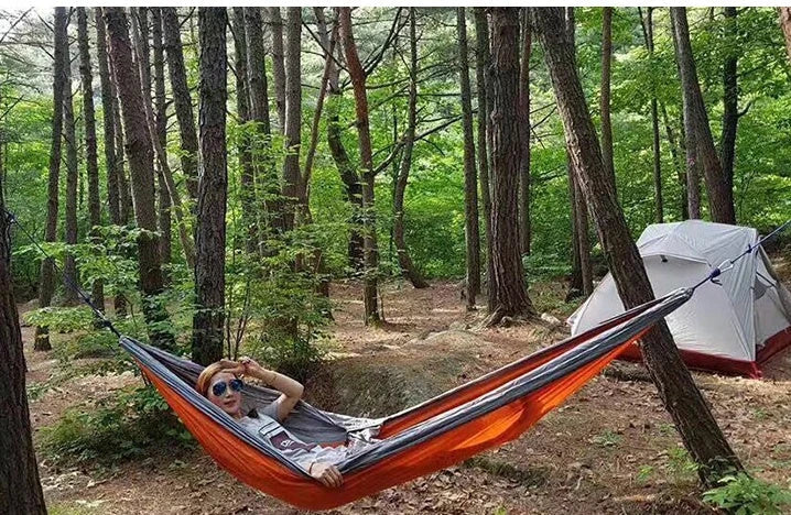 Premium double hammock made with soft, breathable fabric and reinforced ropes for outdoor use