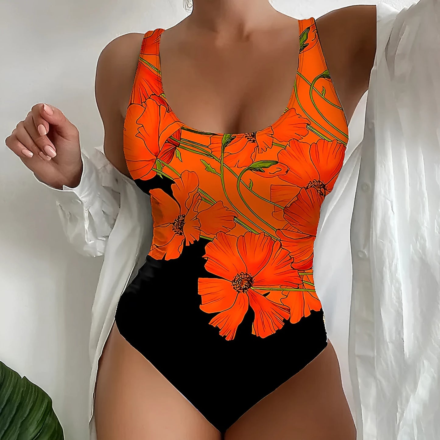 Orange flower print on a backless, slim fit one-piece swimsuit for swimming.