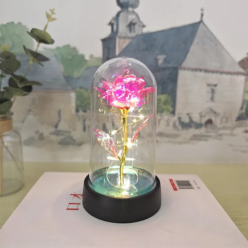 Glass cover small night lamp with plastic flowers, 15cm height, black base, showing colour light options