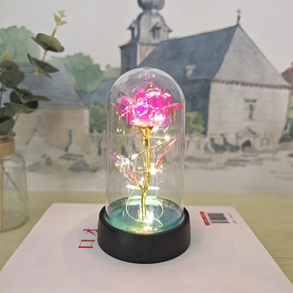Glass cover small night lamp with plastic flowers, 15cm height, black base, showing colour light options