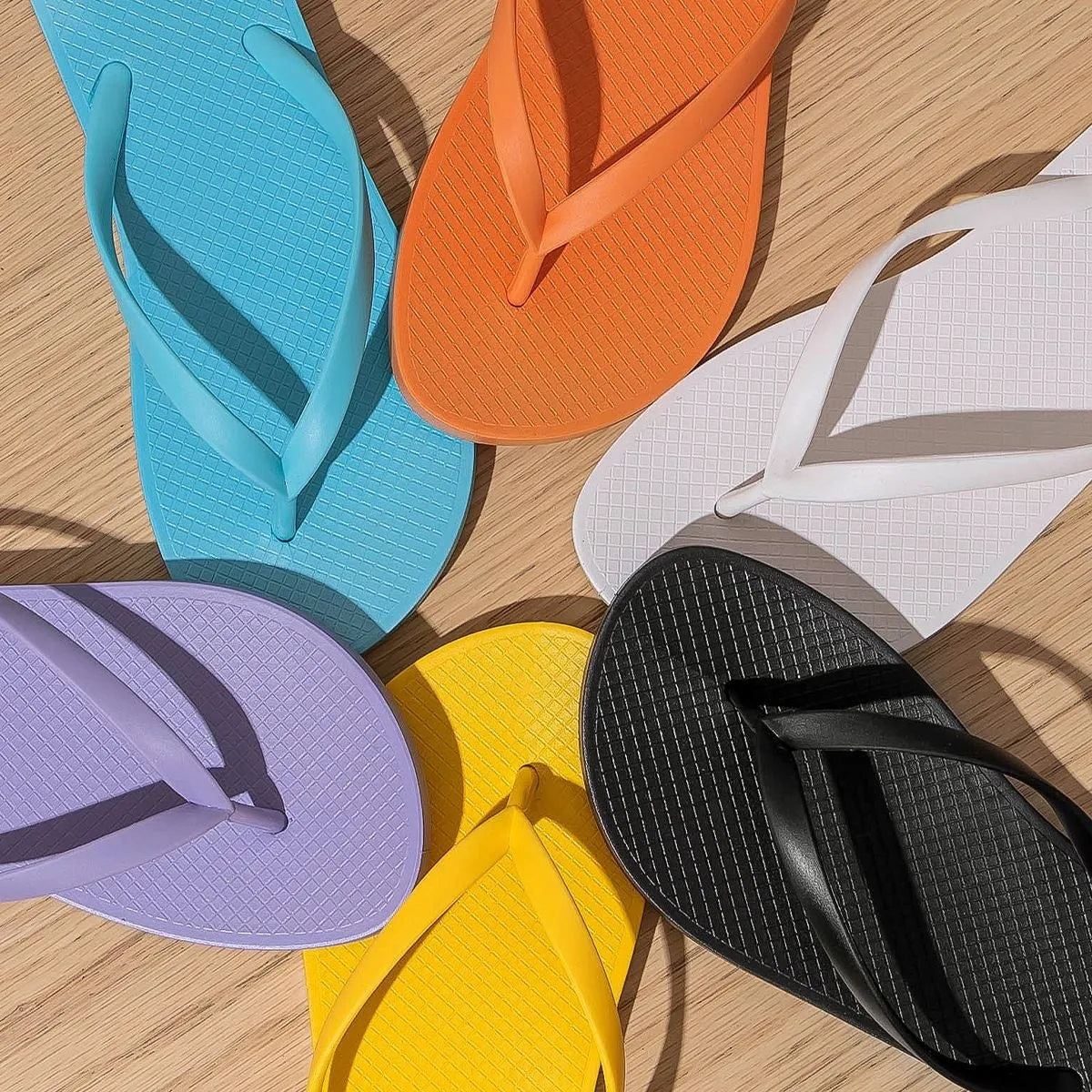 Foldable beach slippers with non-slip soles and hollow-out plastic upper in assorted colours