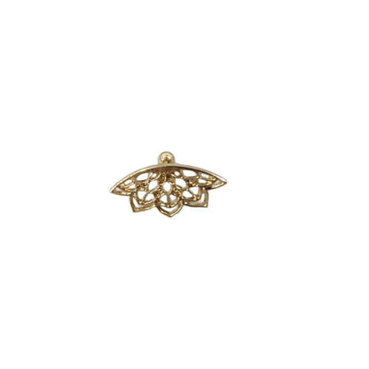 Close-up of a geometric spider web design on a gold-toned metal stud earring.