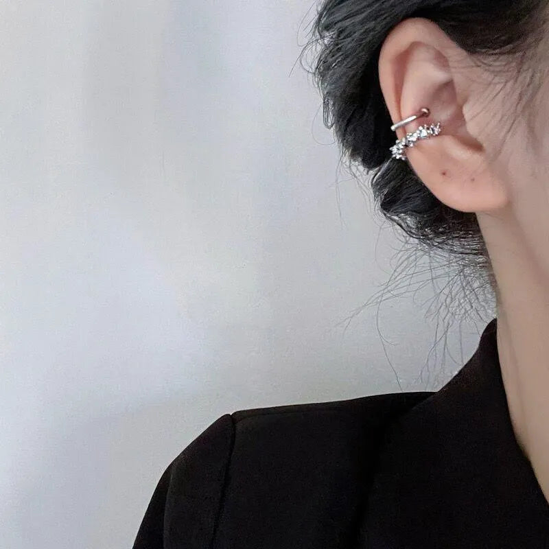 A pair of frosty-finish geometric clip-on earrings with an irregular abstract shape.