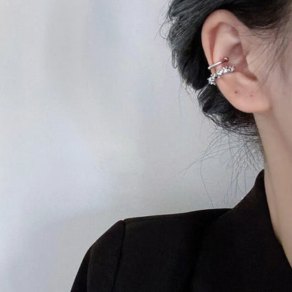 A pair of frosty-finish geometric clip-on earrings with an irregular abstract shape.