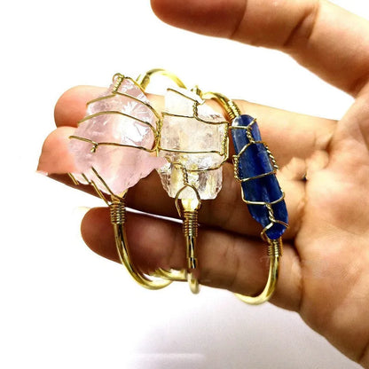 Natural gold winding crystal rough stone bracelet with unshaped geometric design on a wrist.