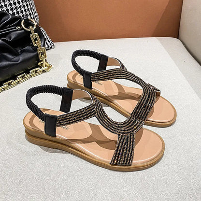 Women's patent leather beach sandals with rhinestone decoration and non-slip soles in gold colour