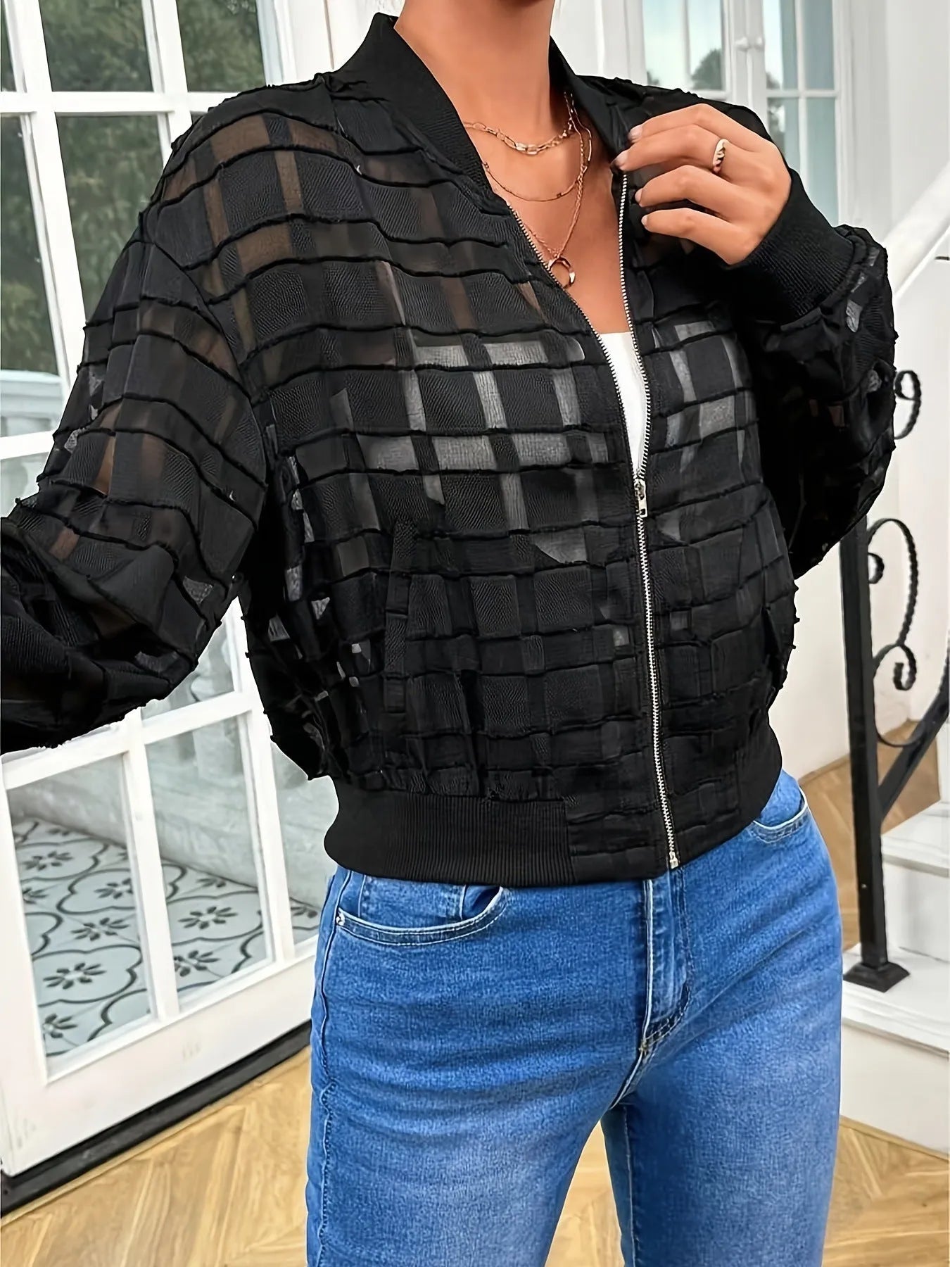 Black women's casual jacket with geometric pattern featuring a distinctive semi-transparent thread zipper and long sleeves.