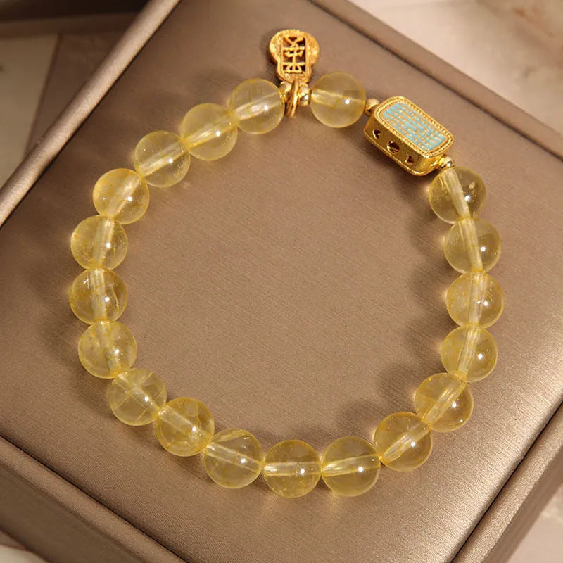 Women's natural yellow citrine crystal bracelet with rhinestone detailing.