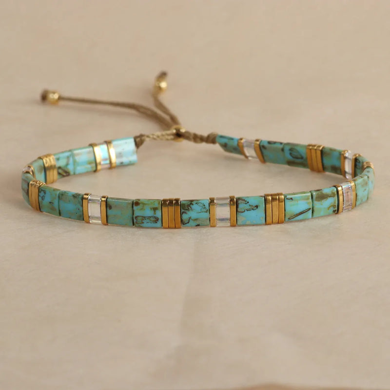 Glass beaded geometric pull bracelet in multiple colour options including milky white, black, retro green, light blue, and red, featuring round bead elements and easy on-off design for wrist-wear jewellery