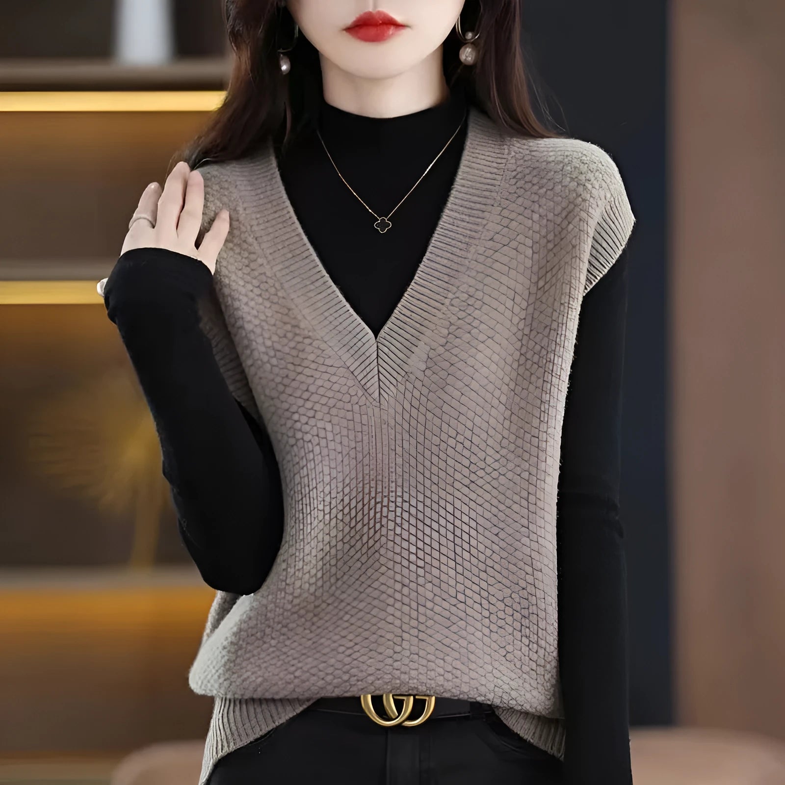 Women's creamy-white knitted sleeveless vest with 3D pattern, V-neck, worn as a layer over a shirt.