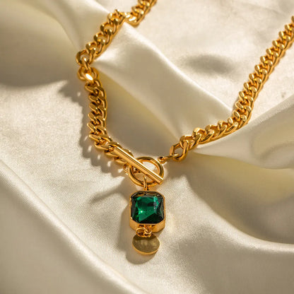 Gold geometric round pendant on a titanium steel Cuban link necklace, 50cm long.