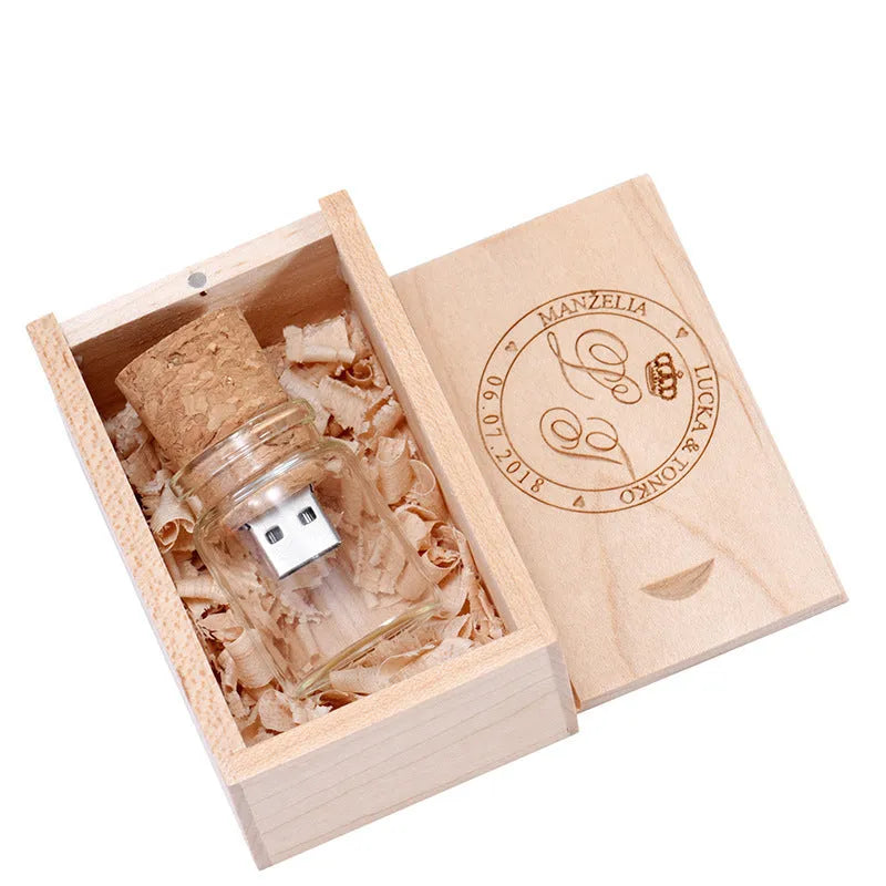 Chocolate brown wooden USB flash drive shaped like a drift bottle with custom engraved lettering on the side