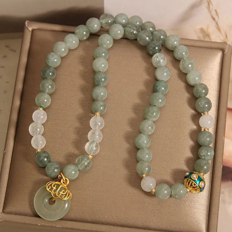 Women's aventurine double-layer jade bracelet with peace buckle closure and rhinestone details
