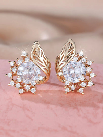 Rose gold plated women's stud earrings with a round flower shape, feather detail, and a central cubic zirconia stone.