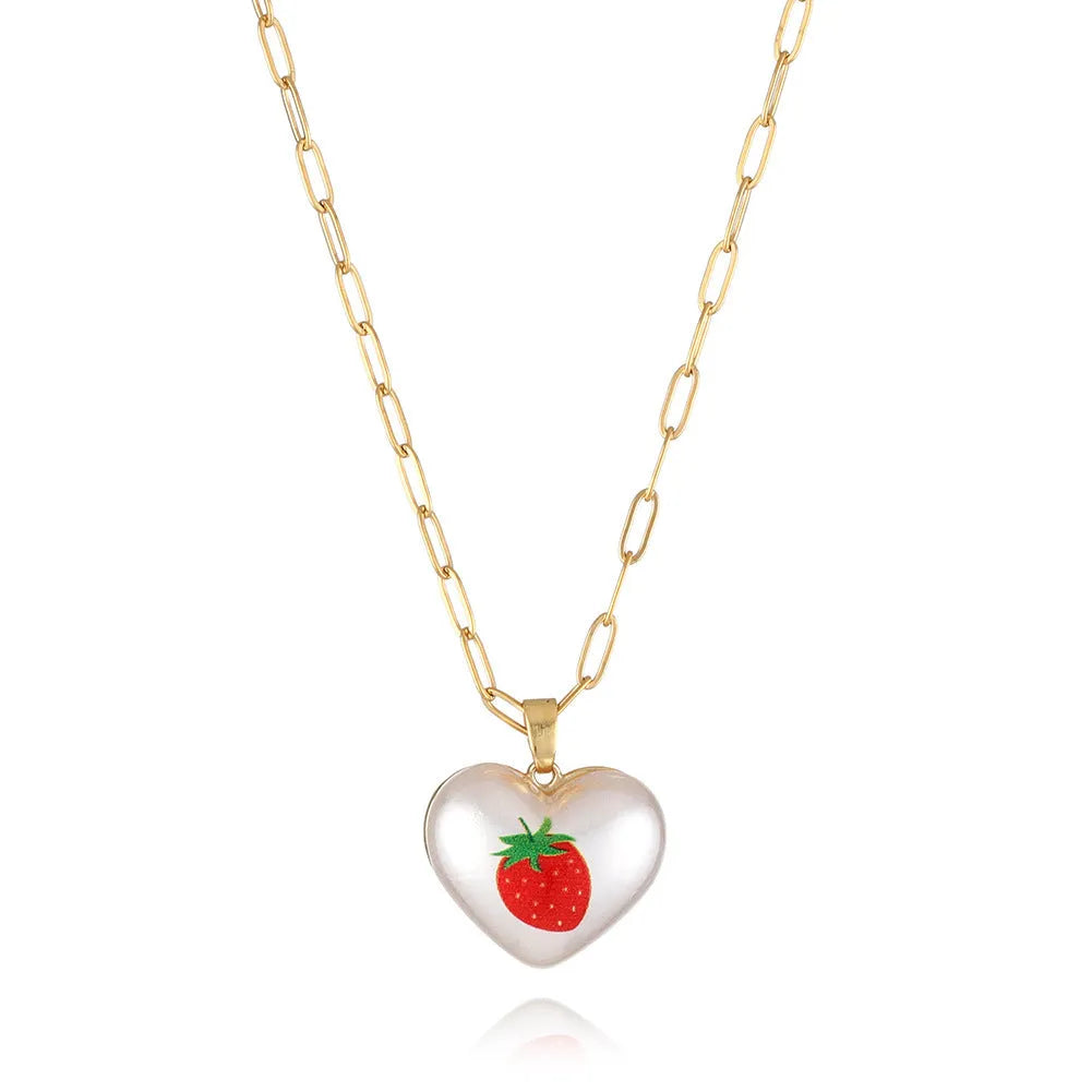Geometric fruit heart pendant necklace on an adjustable chain, showing strawberry, pineapple, apple, pear, and cherry design options.