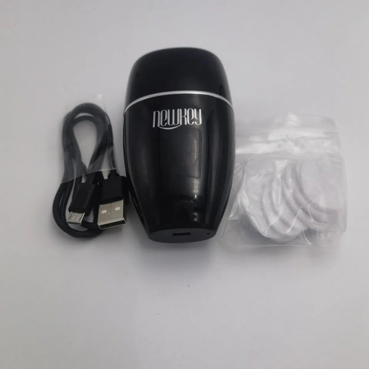 Black and white electric silicone lip plumper with 3-speed adjustment and USB charging cable
