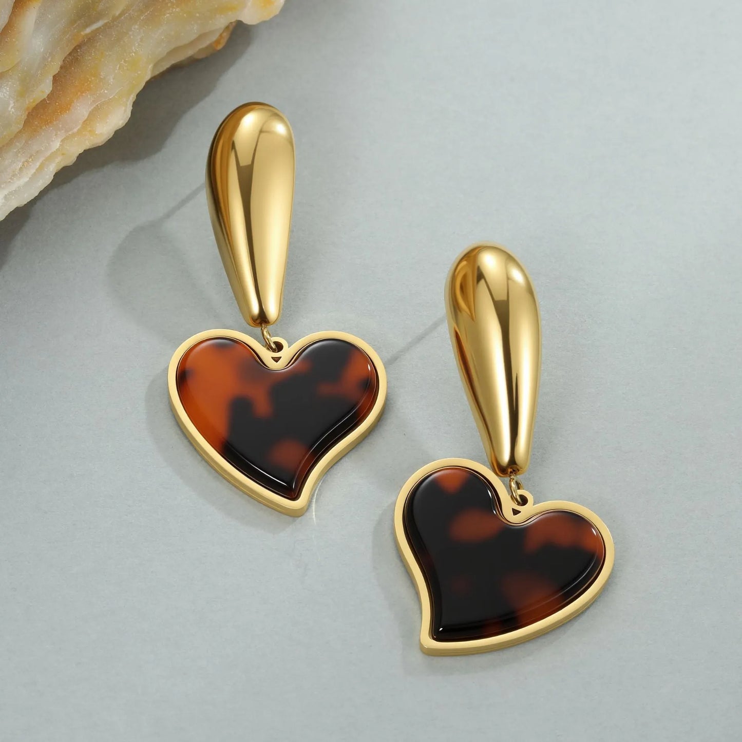 Women's tortoiseshell resin style earrings with 18K gold electroplated finish on stainless steel, heart and floral designs