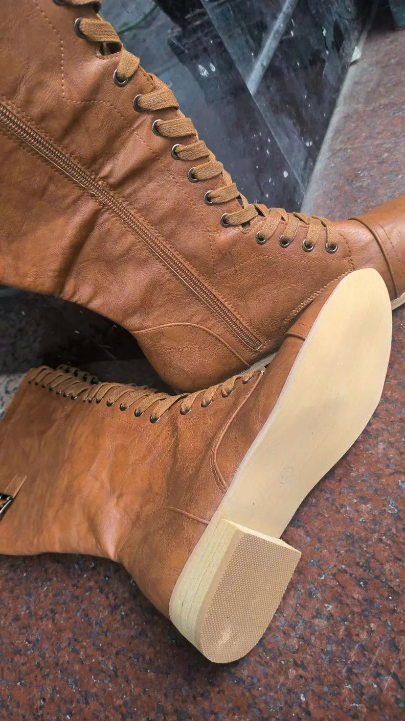 Women's black knight ankle boots with cross straps and buckles over lace-up front.