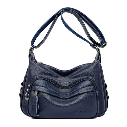 Large blue women's shoulder bag with crossbody strap and multiple internal compartments