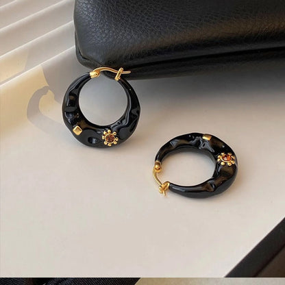 Retro-style alloy ear studs with rhinestone inlay and dripping oil finish in black and red options