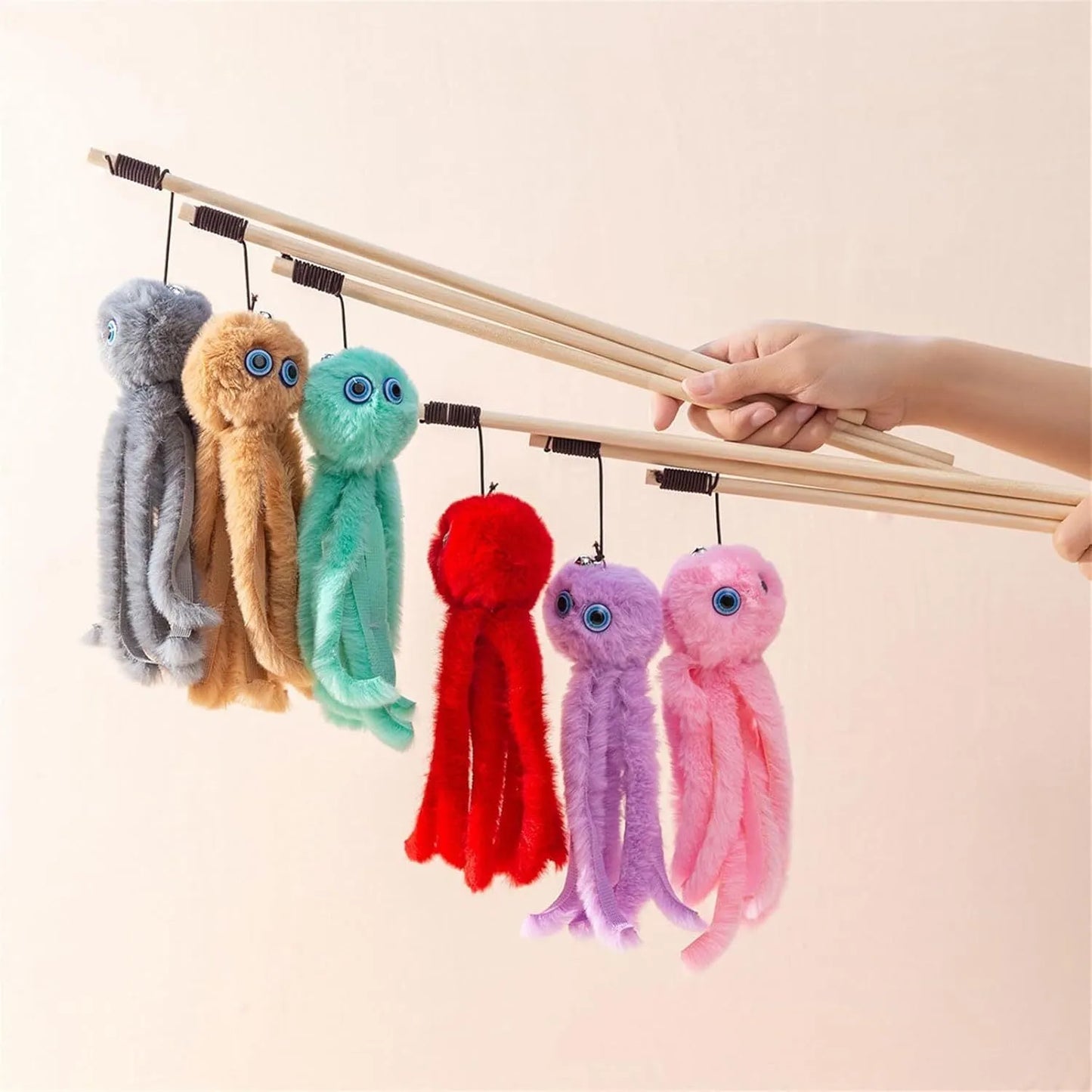 Octopus-themed furry cat toy attached to a long stick, shown in pink colour.