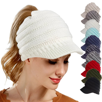Women's acrylic knitted ponytail beanie in a solid colour, shown on a model with a ponytail.
