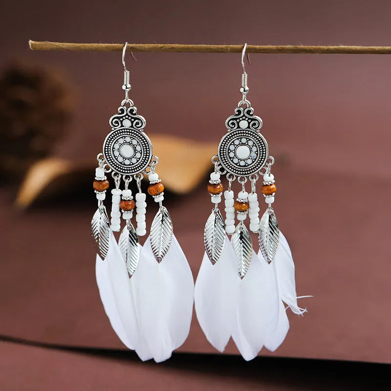 Round drop feather earrings in a bohemian leaf shape with patterned detail, shown in a light pink electroplated colour.