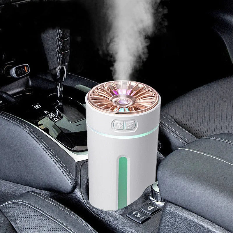 Black portable humidifier with LED lights beside car cup holder showing mist output