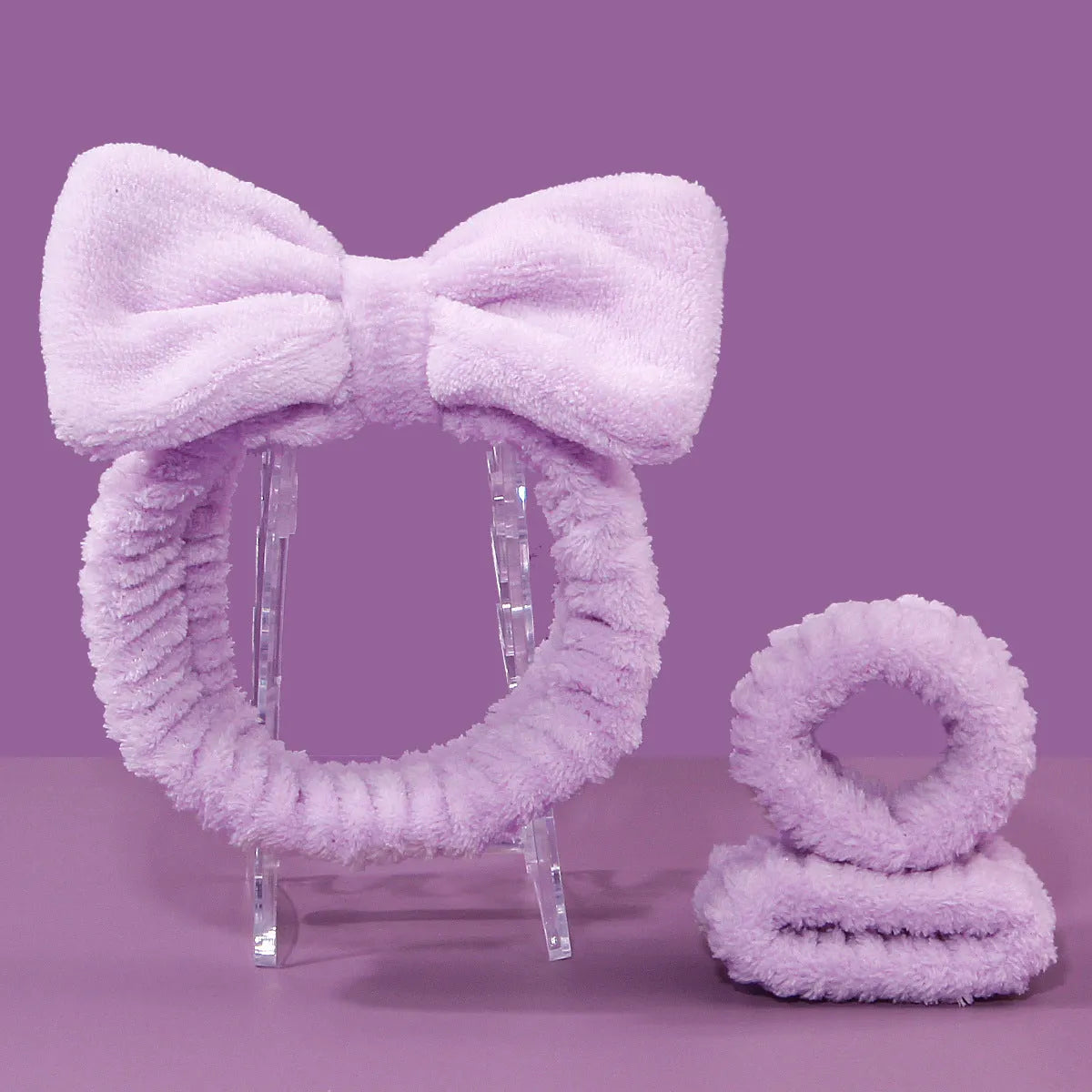 Facial brush set with coral fleece hair band and four nylon-bristle brushes in purple, grey, white, or pink colours