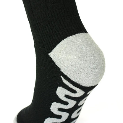 Black and grey mesh smart heating socks with USB cable and battery for skiing.