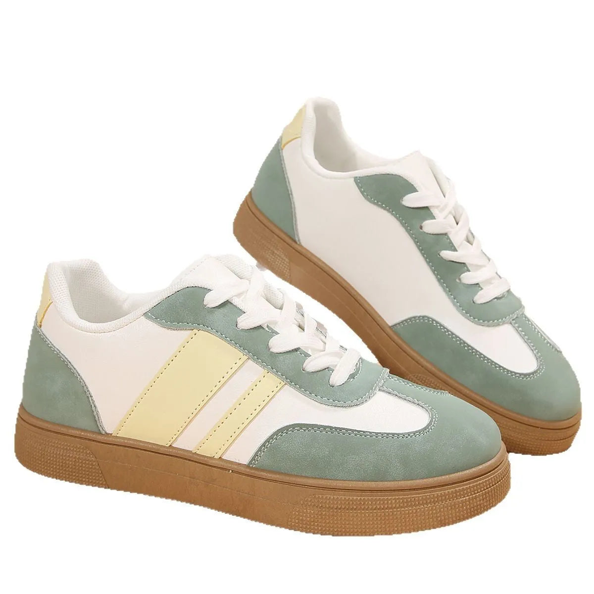 Women's green and white retro-style low-top casual pumps with cross straps and a flat rubber sole.