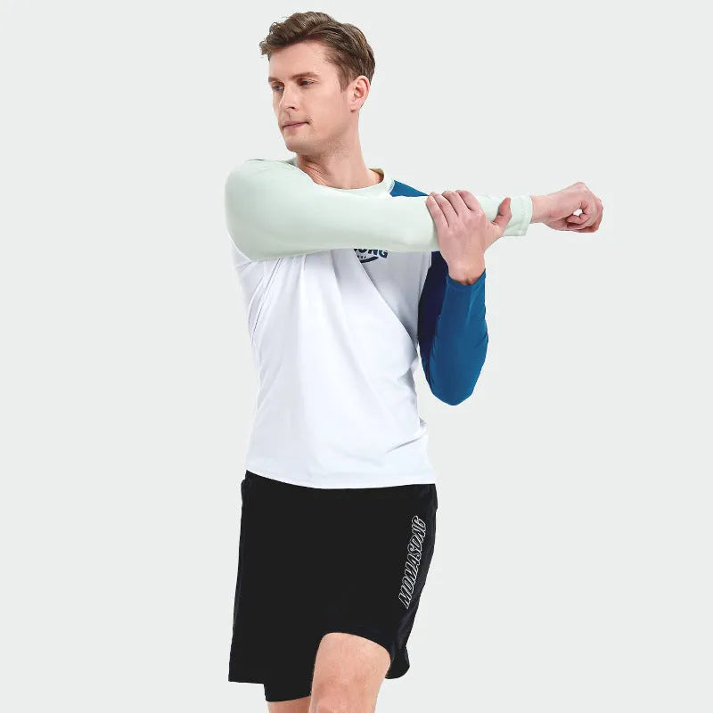 Men's white long-sleeved swim top and matching blue swim trunks set on a beach background.