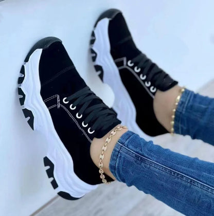 Women's platform sport flats in black, red, blue, and pink with lace-up design and thick sole