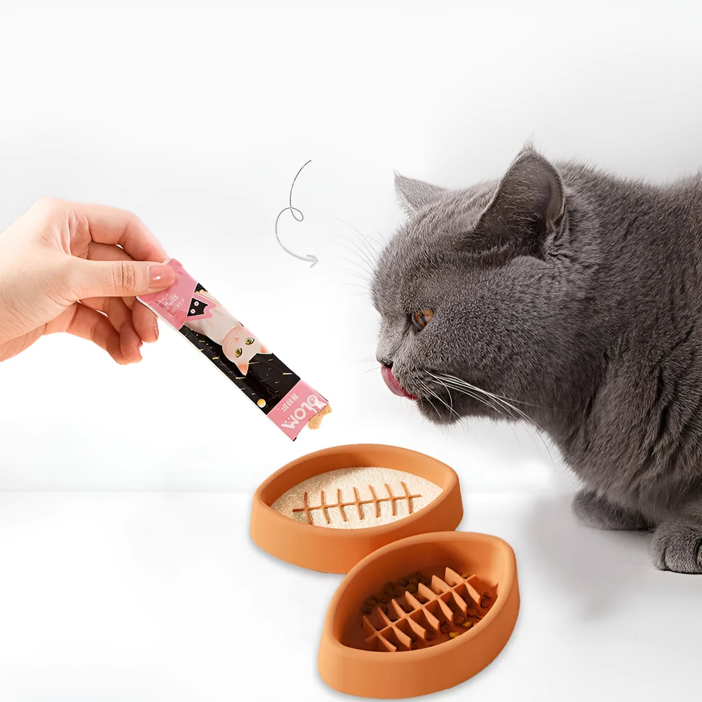 Blue silicone pet slow feeder bowl with textured interior and a white suction cup base on a wooden floor.