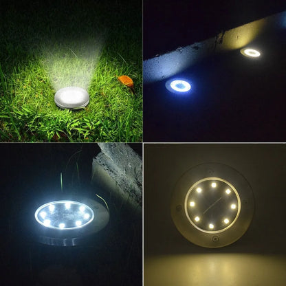 Stainless steel solar garden ground lamp installed in a lawn.