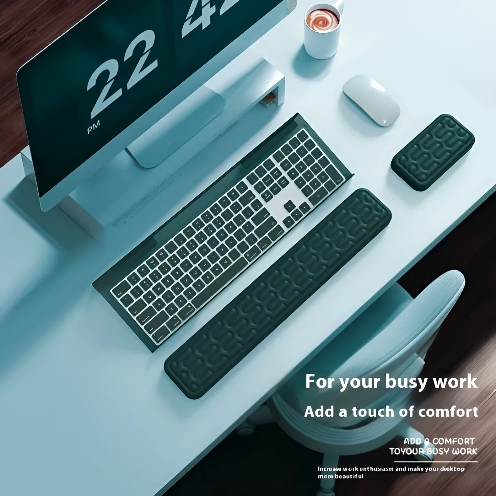 Double-sided black and grey keyboard mouse pad with wrist strap and hand pillow on a desk.