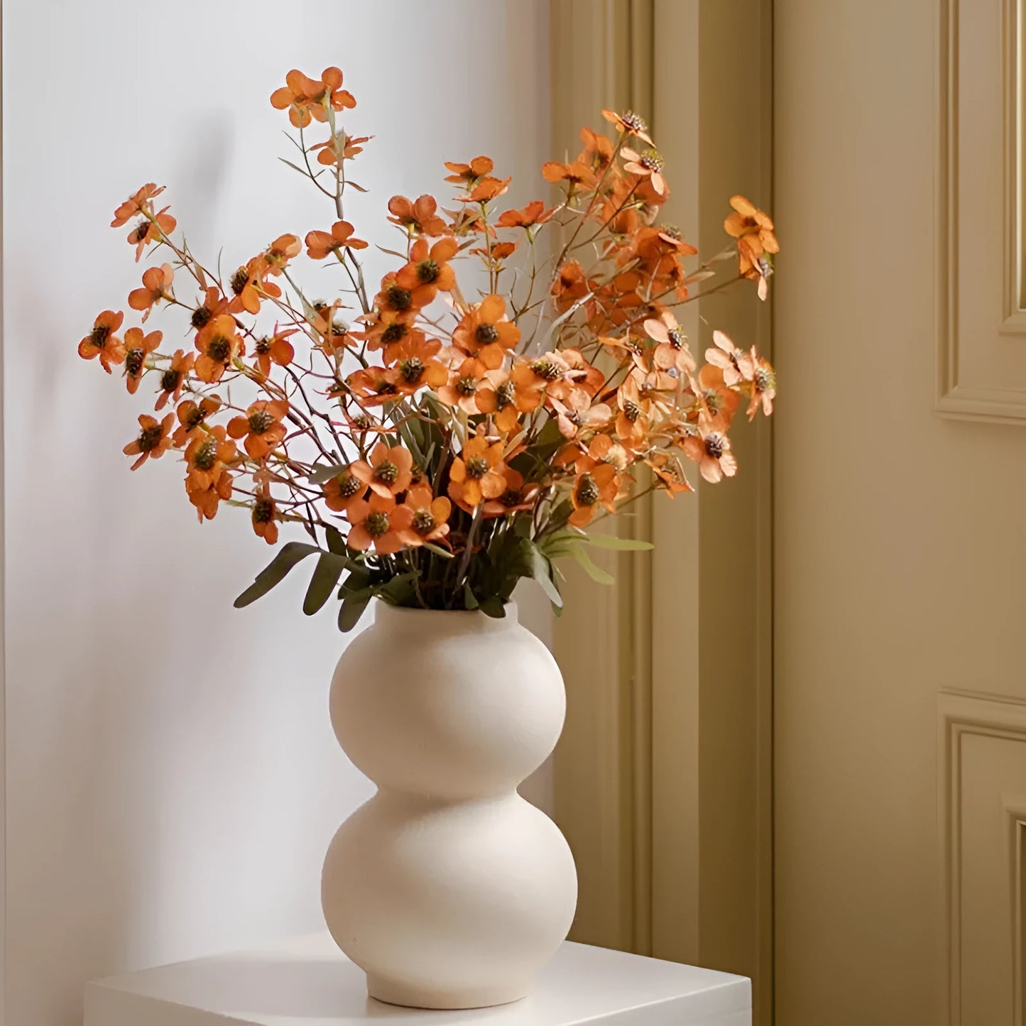 Bundle of four artificial dried flowers in orange, white, pink, and champagne colours for rustic decor