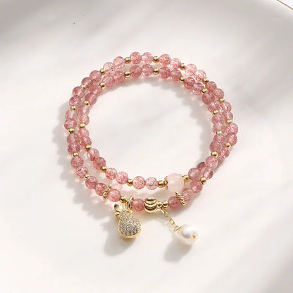 Geometric strawberry quartz crystal bracelet for women on a white background.