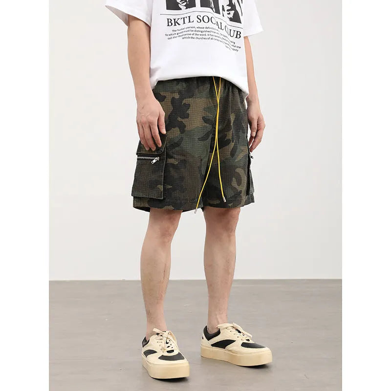 Men's camouflage coloured cargo shorts with multiple pockets and cropped leg length