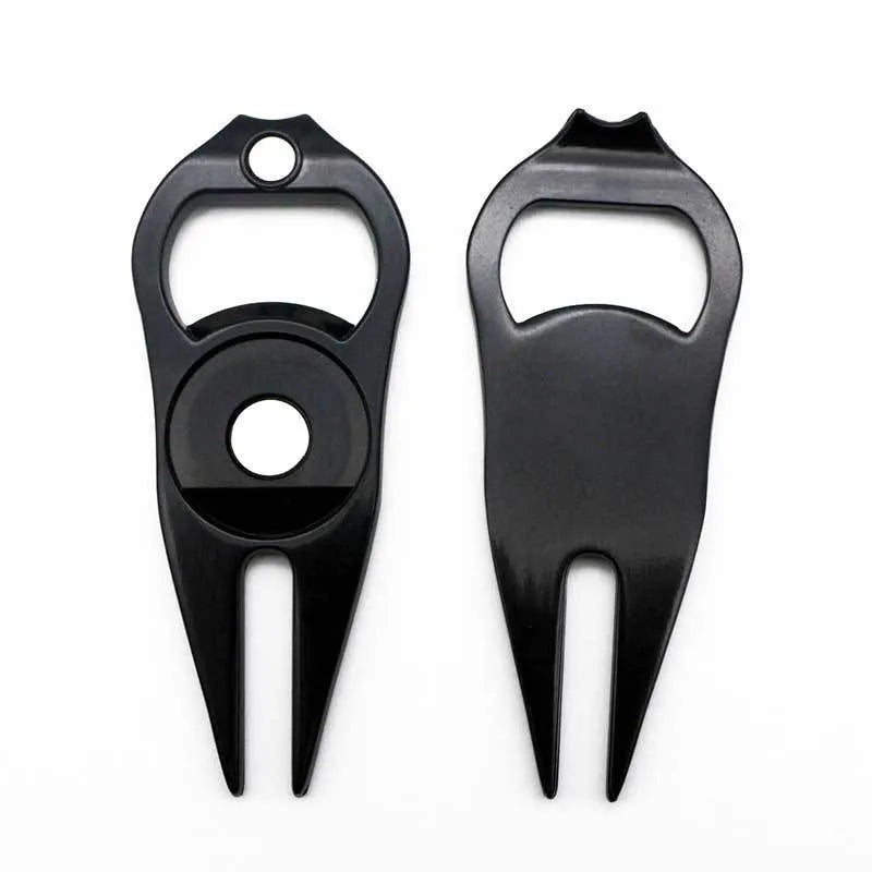 Black zinc alloy golf ball fork and bottle opener tool on a putting green.