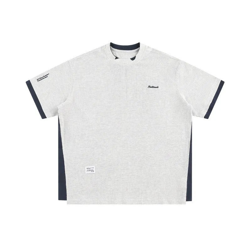 Loose fit waffle fabric T-shirt with retro alphabet embroidery on the chest, shown in navy blue.