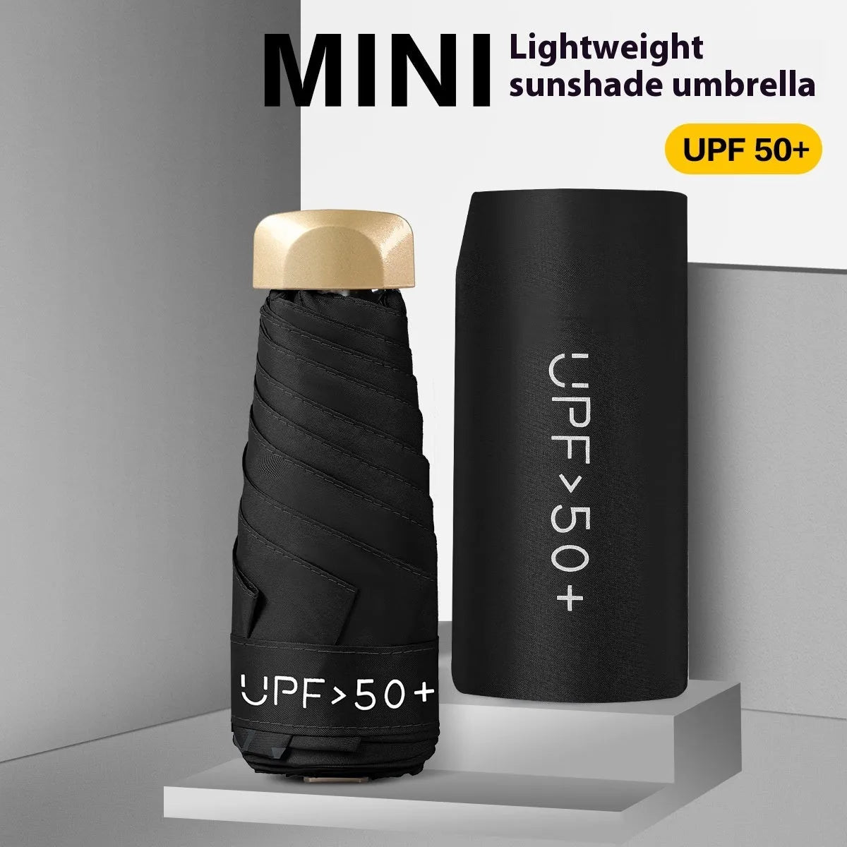 Compact flat-folded sun umbrella in a solid colour, shown next to a hand for scale.