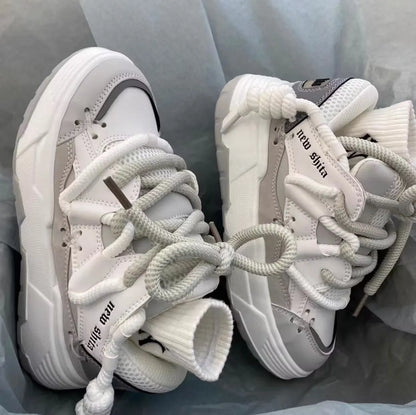Women's grey retro chunky sneakers with thick flat rubber platform sole and lace-up front.